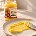 Grainy golden bilona ghee lifted on a spoon